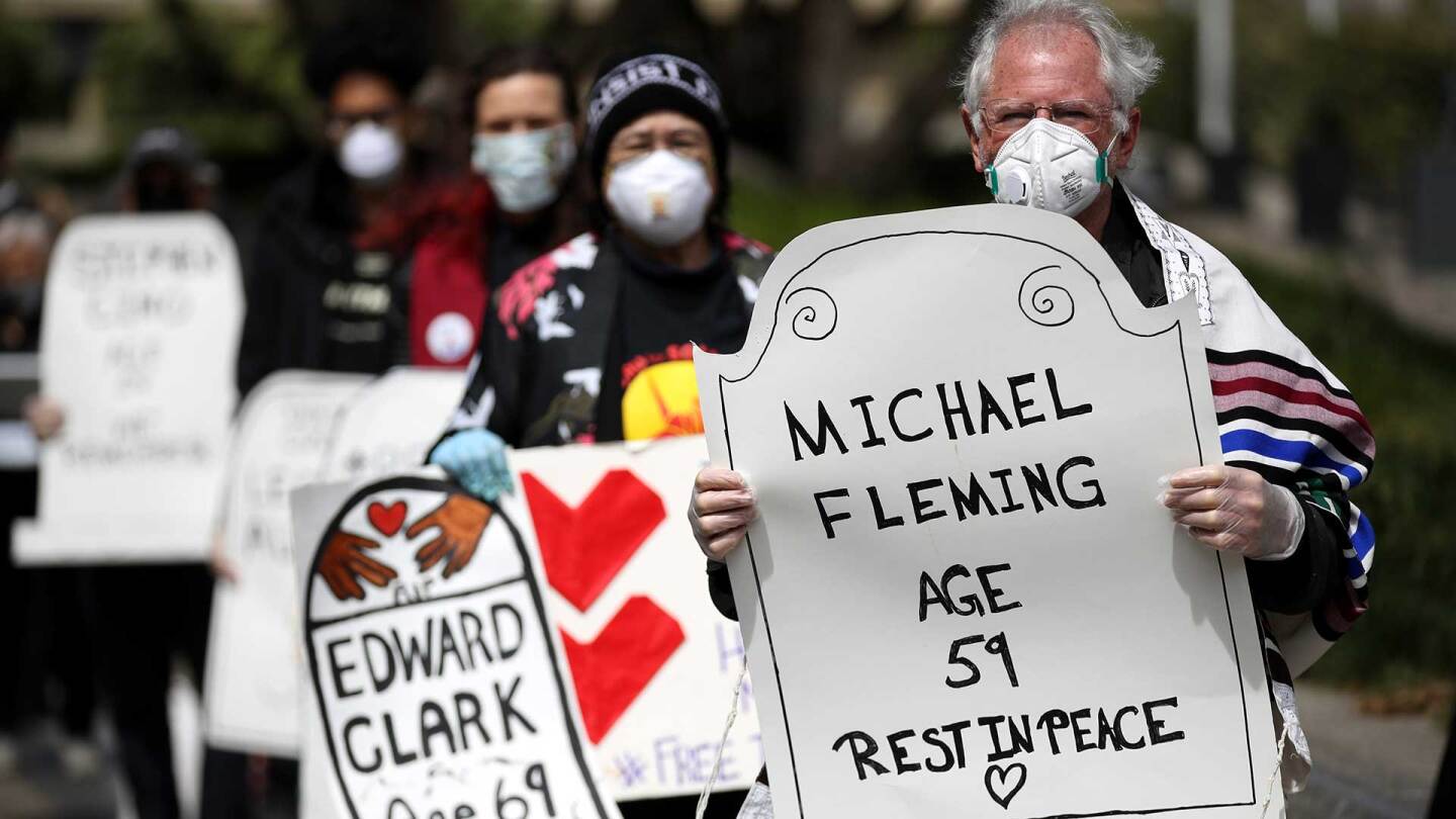 Faith leaders, activists and family members hold a public memorial in front of the Phillip Burton Federal Building and U.S. Courthouse in San Francisco to honor 17 people who died of COVID-19 while in prison or ICE detention. | Justin Sullivan/Getty Image