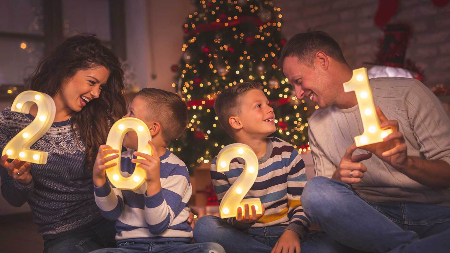 A family holds numbers counting down to the New Year.