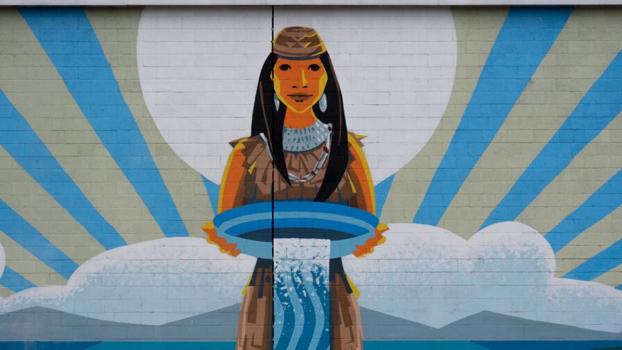 "Rushing Waters" mural in Pacoima. The image shows a Native American woman holding a basin of water. | Justin Cram