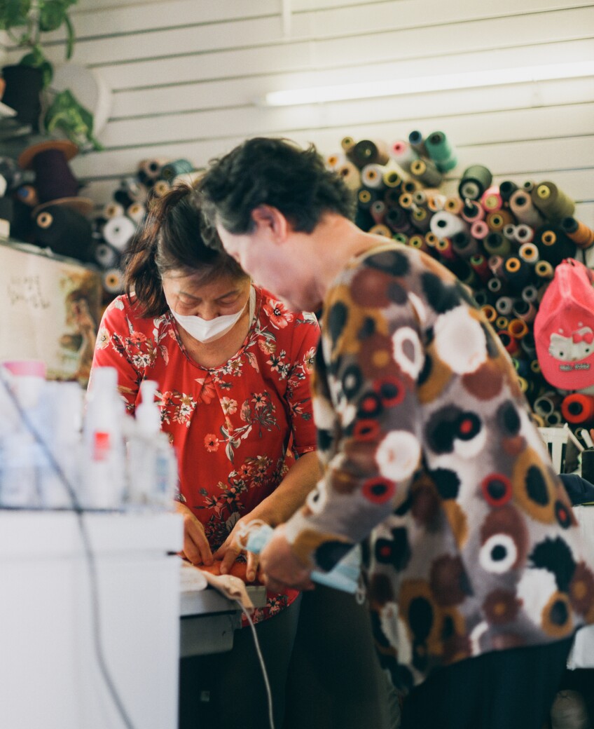 Jessica Pak and her employee work on tailoring clothes.
