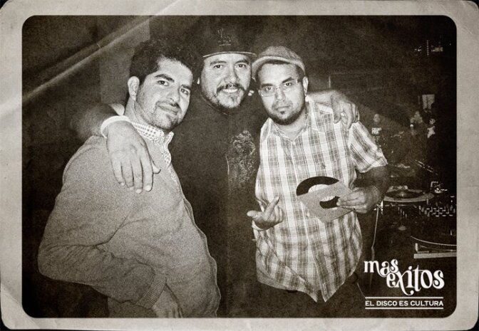 (From left to right) Gary "Ganas" Garay, DJ Lengua and Enorbito stand by a deejay set at Más Exitos.