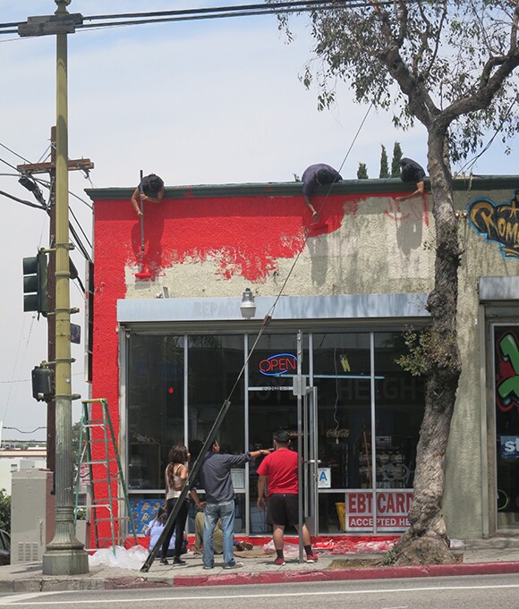 Several weeks of hard work paid off as the outside of Sociedad Market was transformed to a vibrant red. <br />