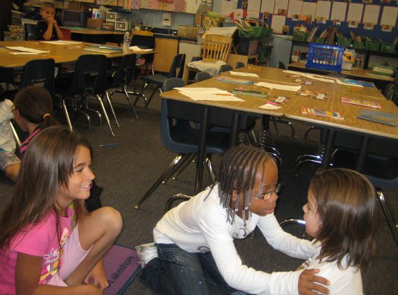 Second graders at McKinley Elementary discussing how they will dramatize a scene from a story.