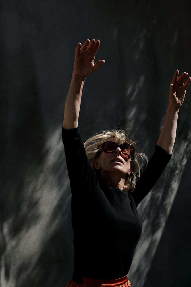 Heidi Duckler stretches her hands towards the sky. | Courtesy of Heidi Duckler