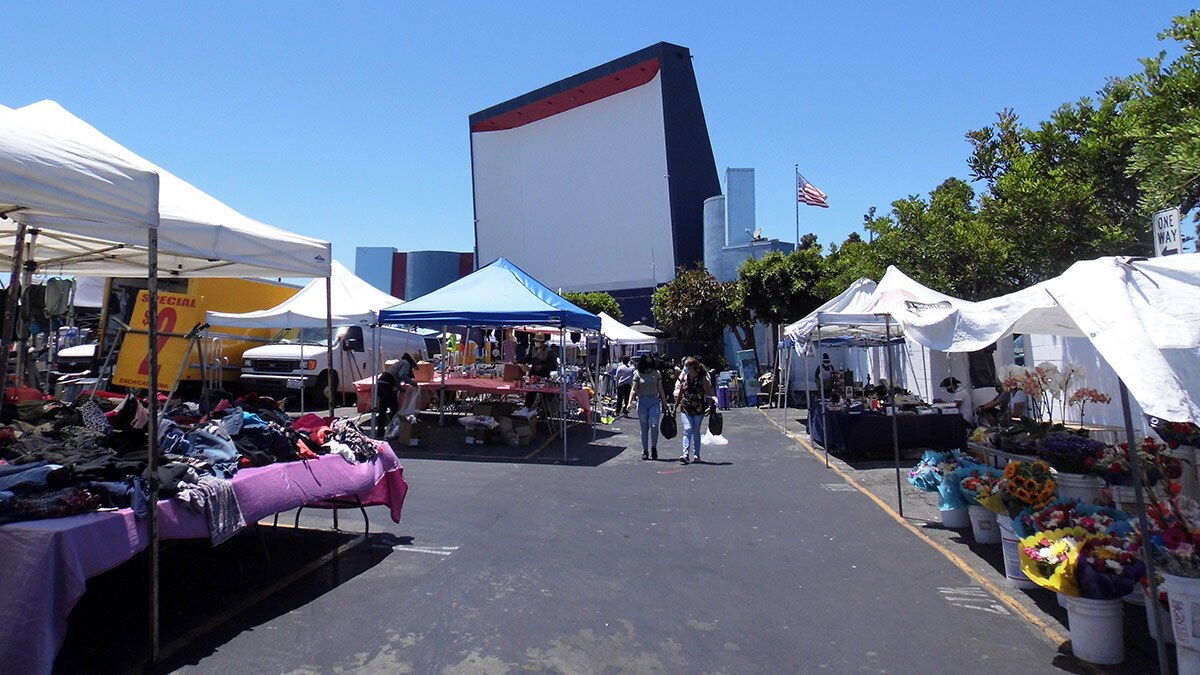 Shoppers stroll along the Roadium Open-Air Market and Drive-In | Sandi Hemmerlein
