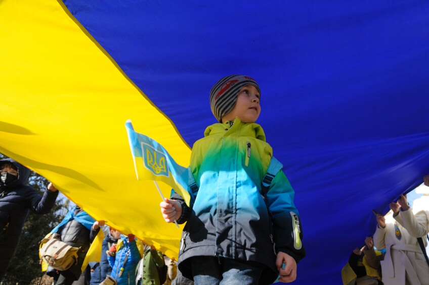 Little boy seen holding a Ukrainian flag in his hand during the Unity march on the Ukraine-Russia border.