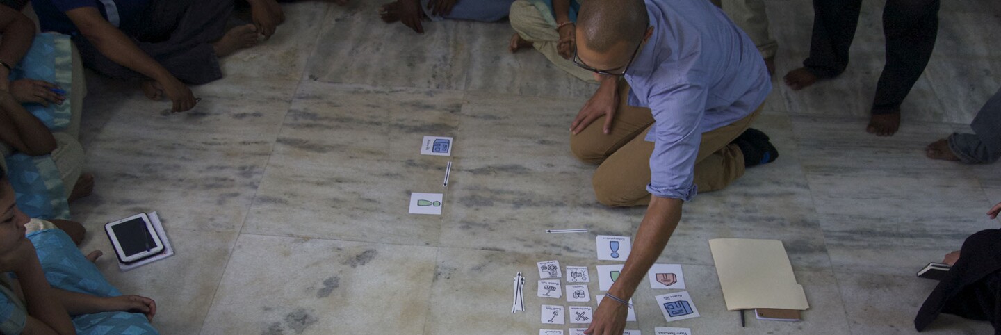 Rafael Smith, a designer at IDEO.org, mapping group decision-making processes with an organization in Southern India. | Danny Alexander, IDEO.org