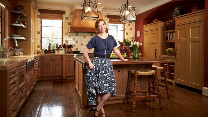 Pati Jinich poses in a kitchen.