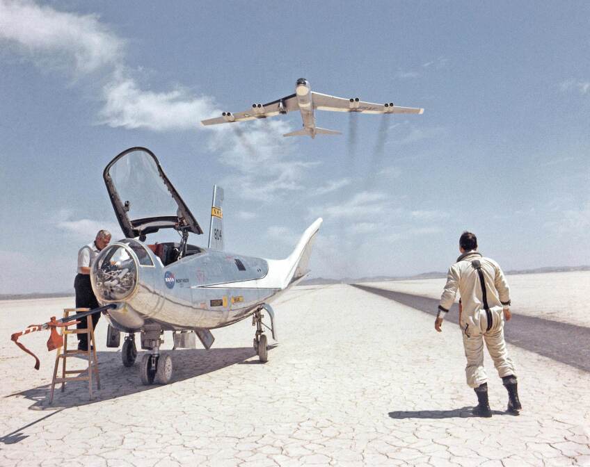 BLUE SKY METROPOLIS hero art. An HL-10 on dry lakebed with B-52 flyby, c. 1966 Courtesy, NASA (SERIES SIGNATURE IMAGE)