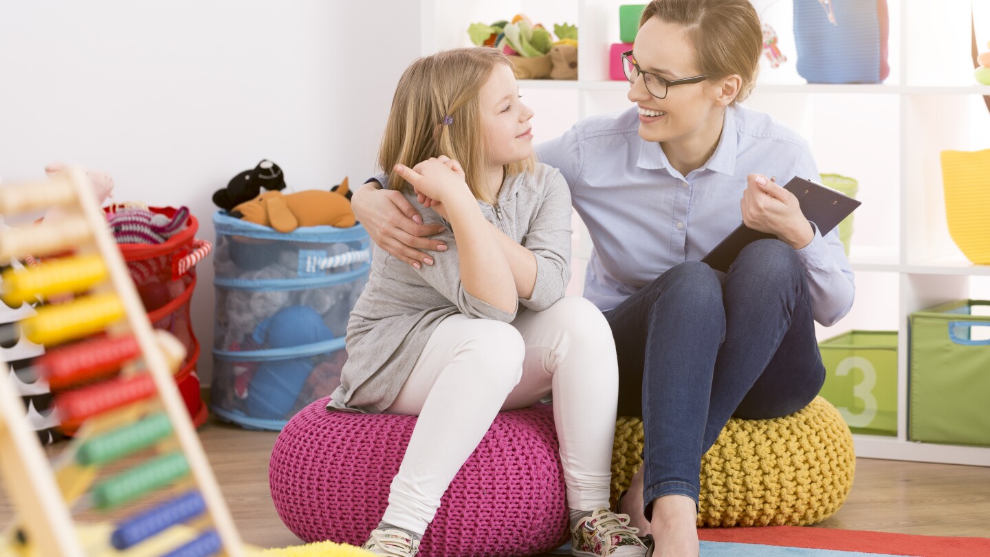 Speech therapist working with child