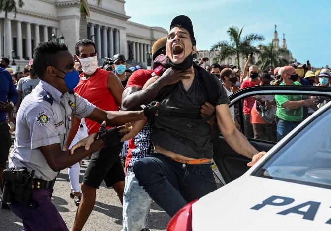 A man is arrested during a demonstration against the government of Cuban President Miguel Diaz-Canel in Havana, on July 11, 2021.