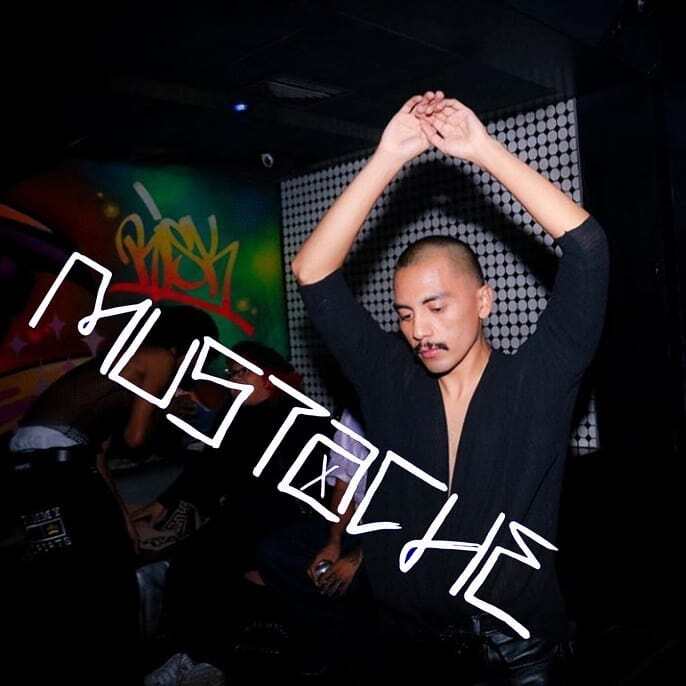 A partygoer with raised hands.
