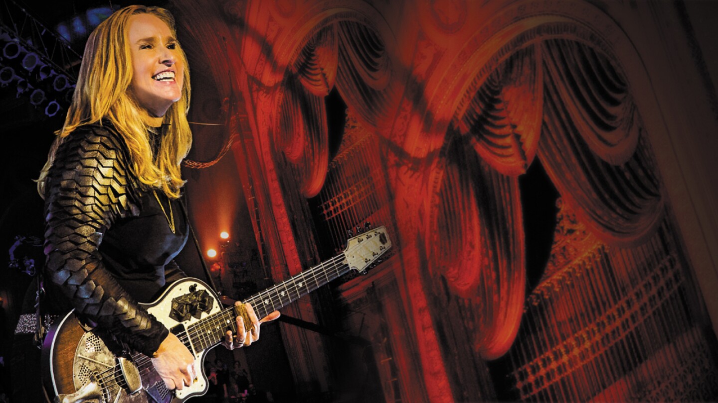 Melissa Etheridge performing on her guitar.