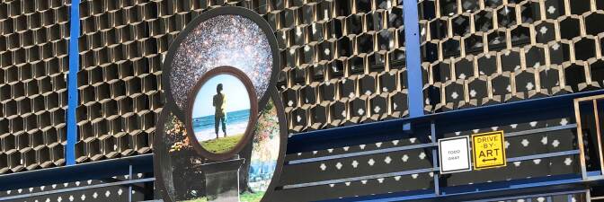 Todd Gray's juxtaposition of a dark-skinned boy atop a pedestal with the cosmos over his head on Crenshaw Boulevard in Leimert Park. | Carol Cheh