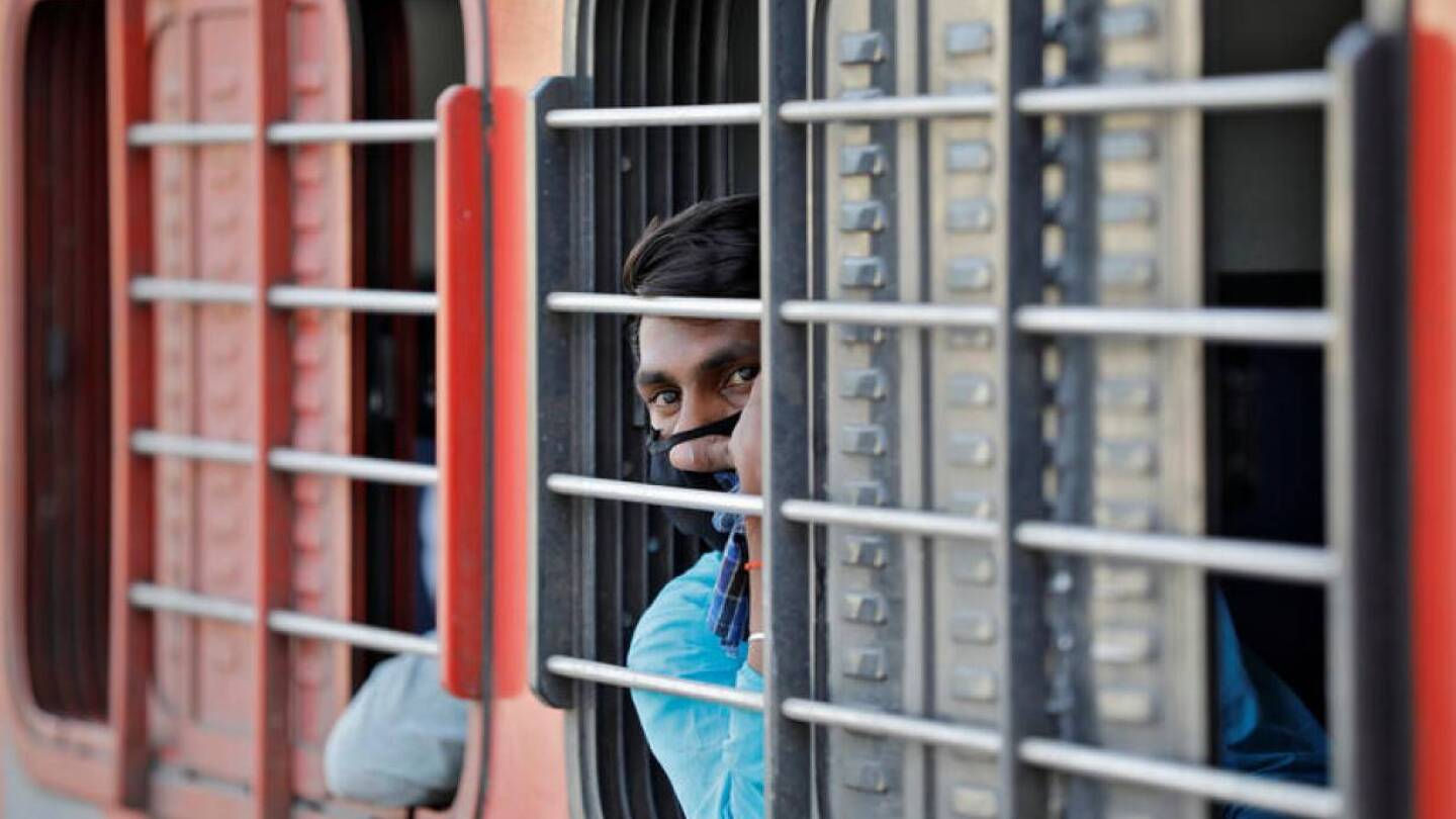 A migrant worker, who was stranded in the western state of Gujarat due to a lockdown imposed by the government to prevent the spread of the coronavirus disease (COVID-19), looks out from a window of a train that will take him to his home state.