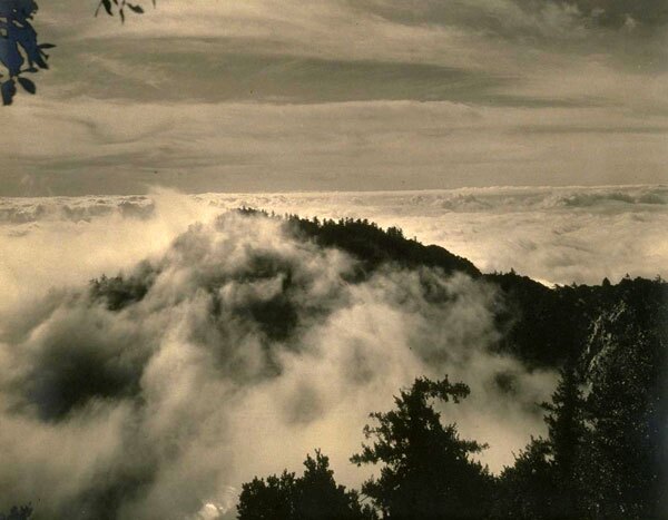 The inversion layer usually keeps fog and other airborne obstructions below Mount Wilson's telescopes. Courtesy of the William C. Barry Collection of Los Angeles Area Photography, Bancroft Library, UC Berkeley.