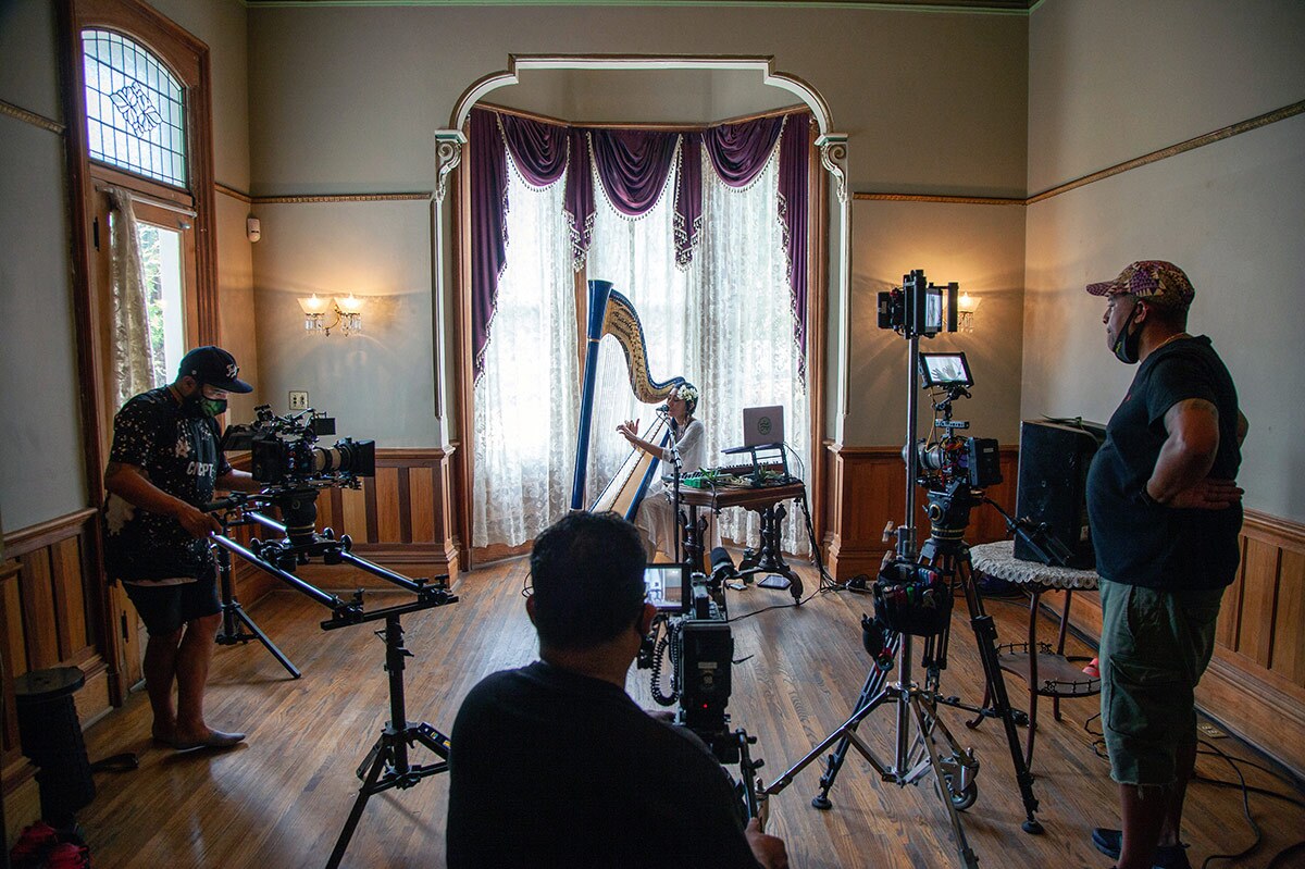 The Grand Performances team films Low Leaf performing inside the Perry House at Heritage Square Museum. | Azul Amaral