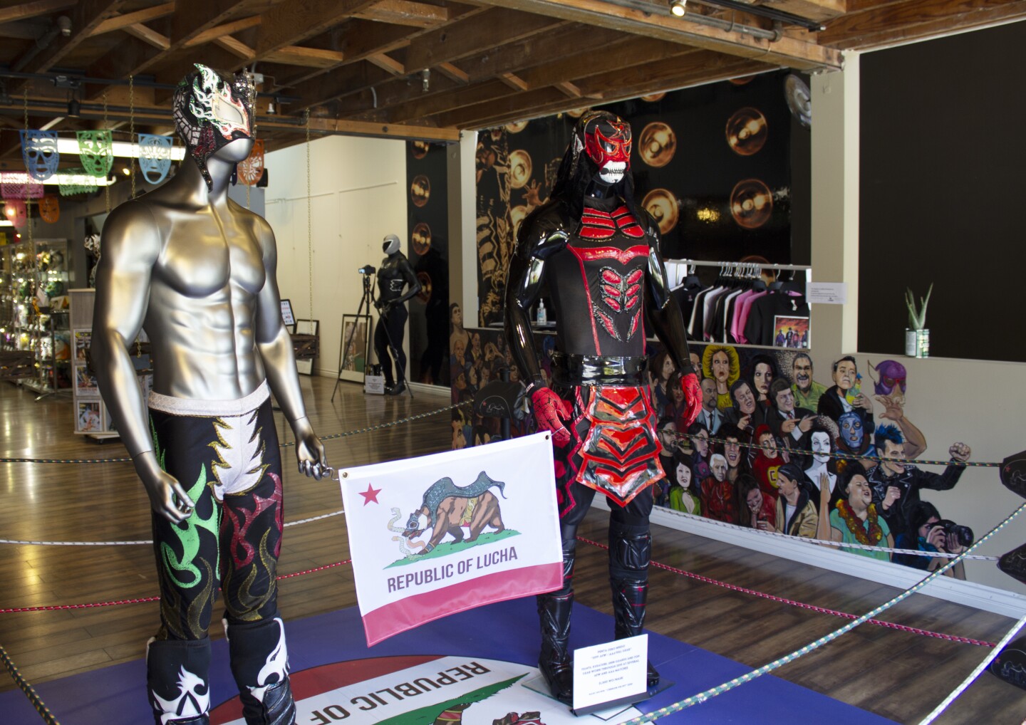 Two mannequins wearing lucha libre outfits.