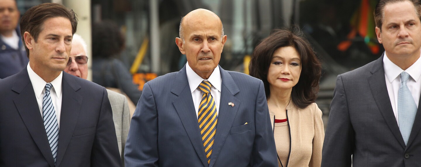 Former Los Angeles County Sheriff Lee Baca, walking with wife and attorneys to a court hearing in 2017 cropped