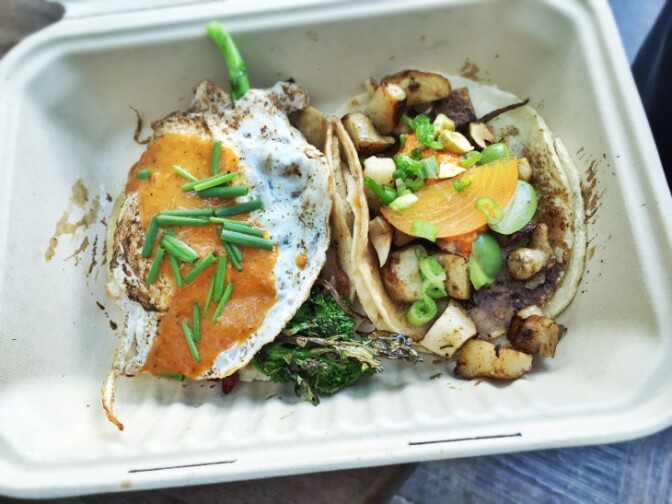 A pre-pandemic meal from Guerilla Tacos: A bacon taco with a fried egg, baby rapini, cheddar, arbol chile and chives (left) and a sunchoke taco with persimmon, castlevetrano olives, almond chile, scallions and pistachio. | T.Tseng/Flickr Creative Commons