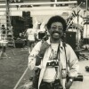 A young man with a lot of cameras hung around his neck.
