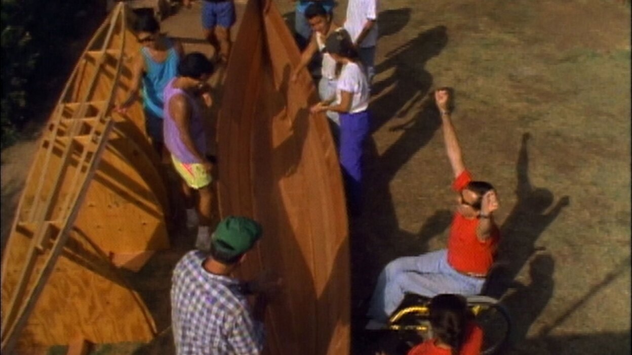 Archival footage of team celebrating milestone while building a ti'at. | Still from "Life & Times" episode "Launching a Dream"
