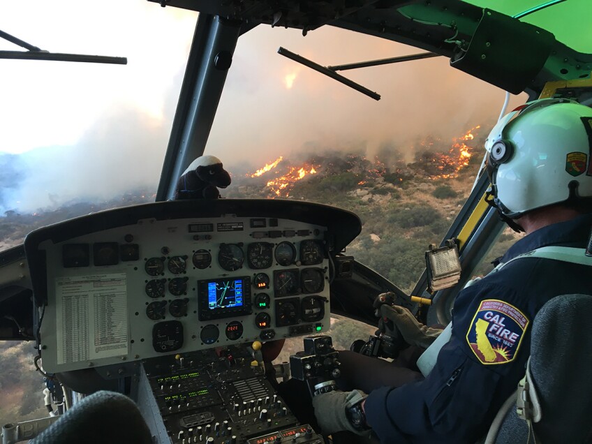 A helicopter pilot flies over a fire. | Courtesy of Cliff Walters