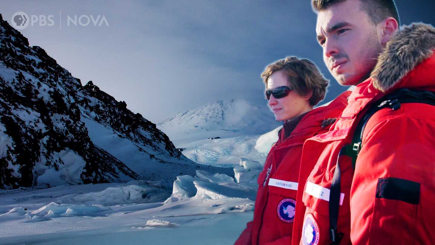 A man and a woman in thick red winter coats in a thumbnail image for "Antarctica: Journey to the Bottom of the Earth."