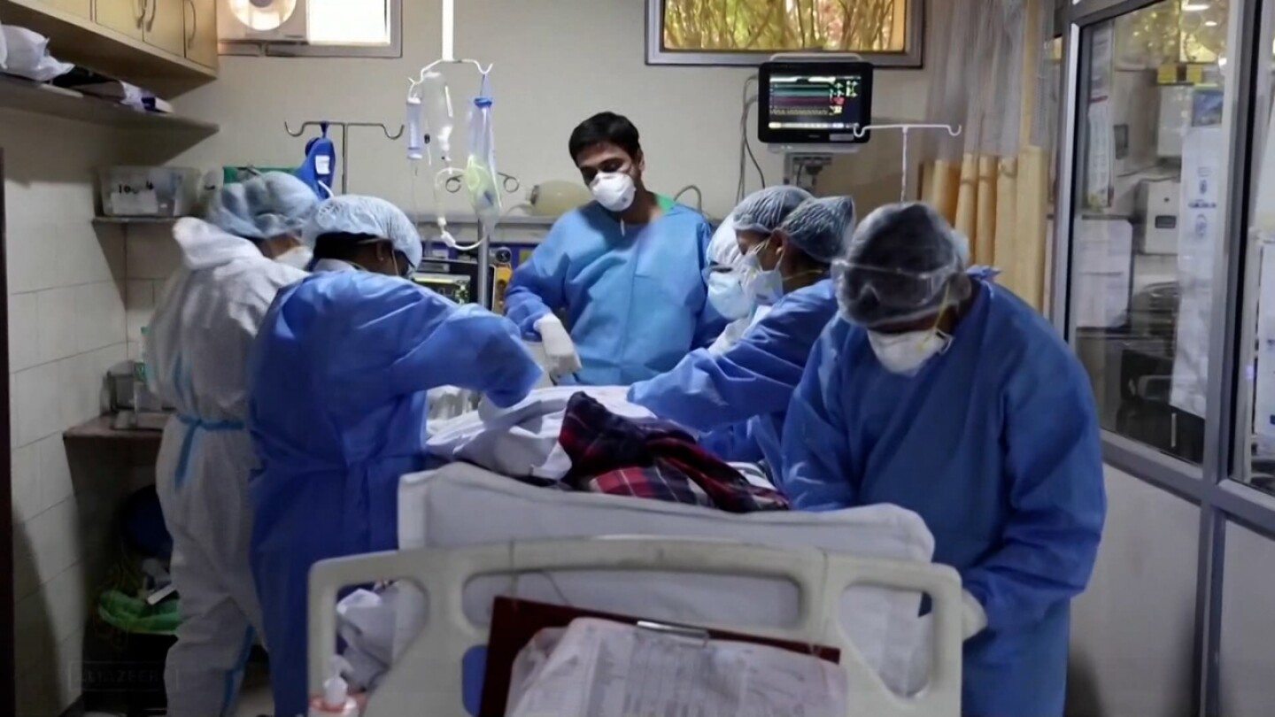 A group of healthcare workers in India treating a coronavirus patient.