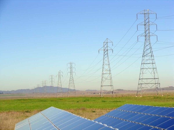 Existing high-voltage transmission lines above test panel array cross the project site | Photo courtesy First Solar