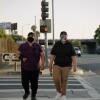 Two people cross the street in Los Angeles