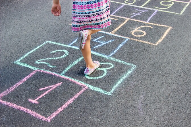 girl plays hopscotch