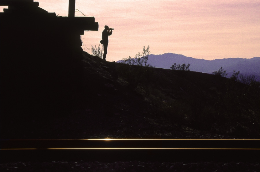 Richard Steinheimer toting his heavy camera bag and photographing another sunset, at Lavic in the Mojave. | Shirley Burman