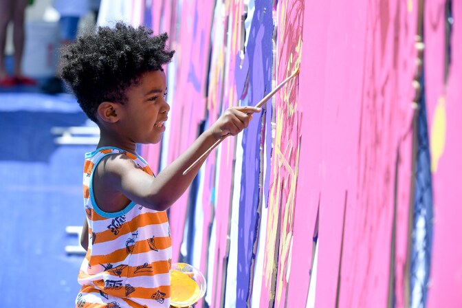 A young aspiring artist enjoys the chance to paint away during the reopening of The Music Center’s newly renovated plaza during The Music Center’s Splish Splash Plaza Bash. | Courtesy of The Music Center.