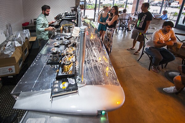 Geoff Gouveia behind an espresso bar made from a Cessna wing. | Photo: Douglas McCulloh