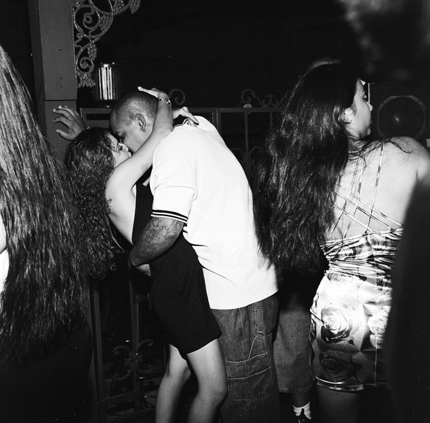 Couple kissing among dancers