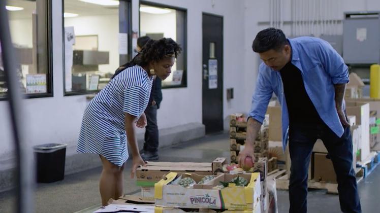 Olympia Auset of SÜPRMARKT selects produce with Roy Choi. | Still from "Broken Bread"