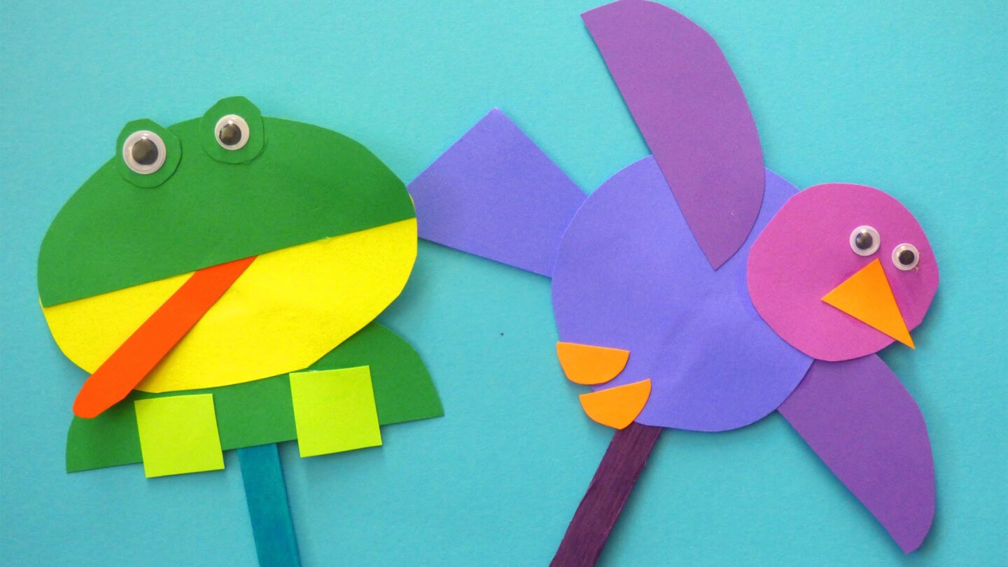 A pair of frog and bird puppets on top of a blue background