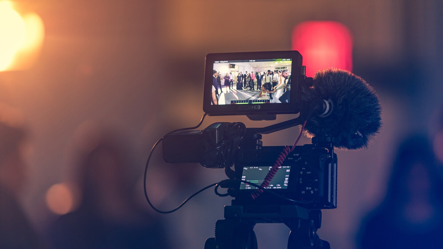 A video camera showing an image of people gathered in the frame | Kushagra Kevat/Unsplash