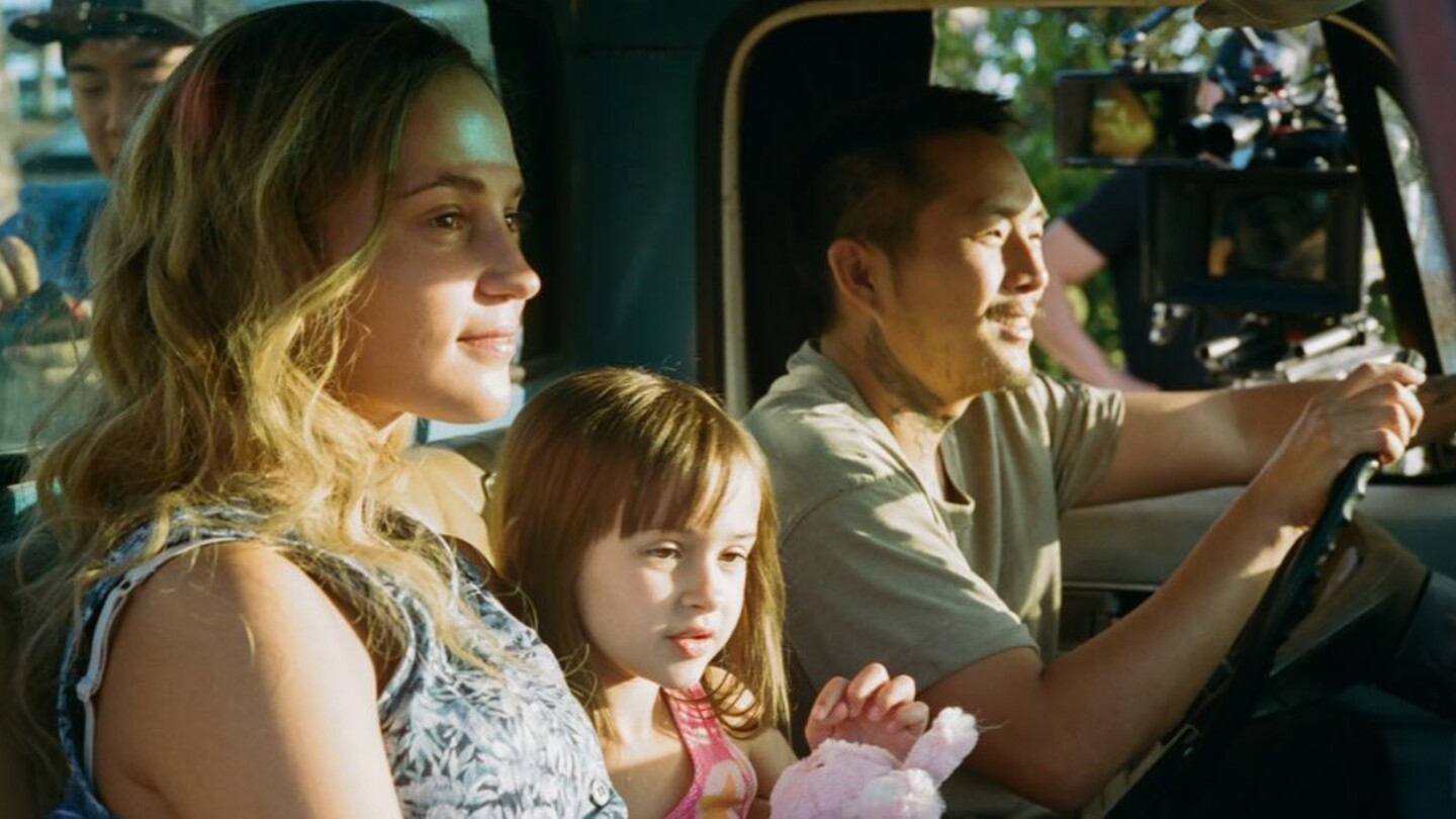 Alicia Vikander, Sydney Kowalske and Justin Chon sitting inside a truck in a scene from "Blue Bayou."