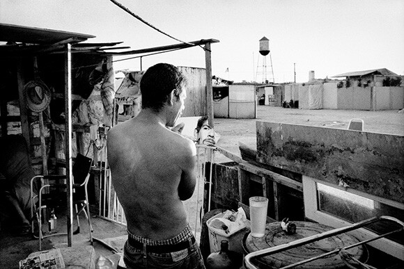 Jobless man shaves at his shantytown home. Fresno, California. The Dispossession | Photo: Matt Black