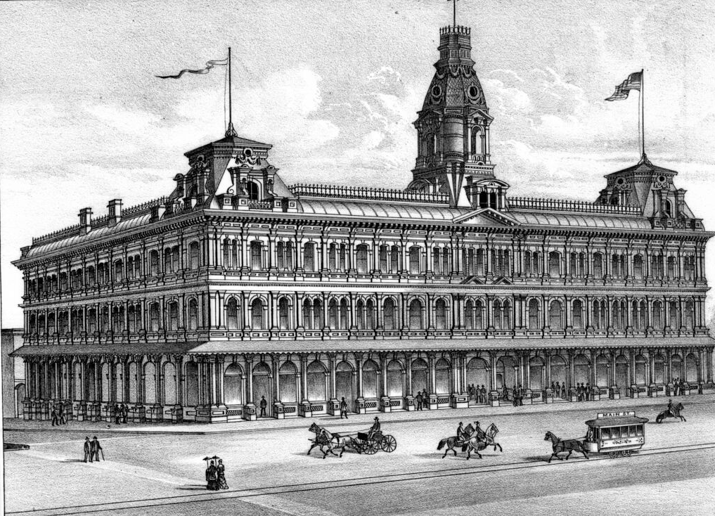 Photograph of a lithograph of the Baker Block on the corner of Main Street and Arcadia Street in Los Angeles, 1880-1889. The three-story building is at center and its façade is facing slightly to the right. It is a large rectangular building with short towers on the corners and massive domed tower at center. There are flags on both of the corner towers. The building is Victorian style, with large arched windows on all three levels. There are several pedestrians near the entrances to the building, as well as in the street in the foreground. Three horsemen, a horse-drawn wagon, and a horse-drawn streetcar are also visible in the streets.