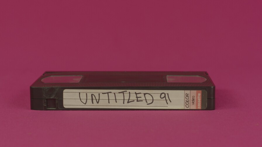 Hector Gachan music video still: a VHS tape on a fuschia background. Tape reads "Untitled 91," which is the name of the song.