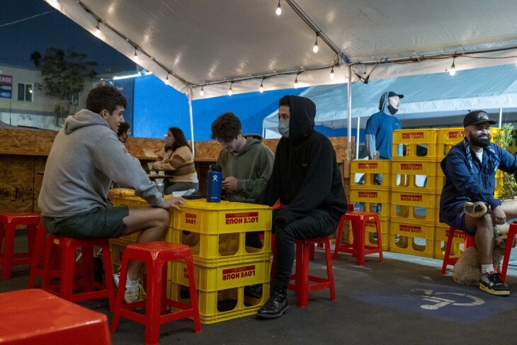 Diners eat inside Love Hour's pop-up parking lot dining tent, prior to the city of L.A.'s latest pandemic dining restrictions. | Chava Sanchez/LAist
