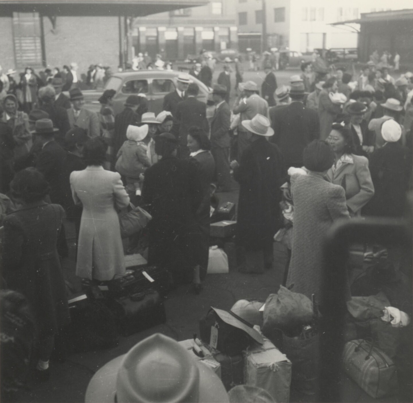 JANM- Japanese Americans wait at a Los Angeles, California, train station. They are bound for Parker, Arizona (Poston concentration camp), May 29, 1942.jpg