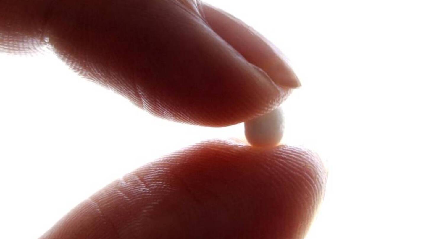 ARCHIVE PHOTO: An illustration picture shows a woman holding a birth control pill at her home in Nice January 3, 2013. | REUTERS/Eric Gaillard