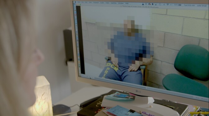 KQED reporter views a once-secret video of prisoner inmate describing sexual abuse | Still from "The Fight To Know"