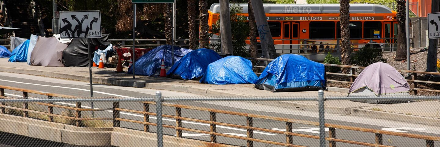 Tents housing homeless over a bridge | iStock