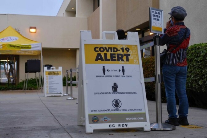 A person waits in line to vote at the O.C. Registrar. | Chava Sanchez/LAist