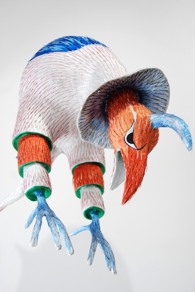 A colorful bird-like figure is rendered as a piñata.